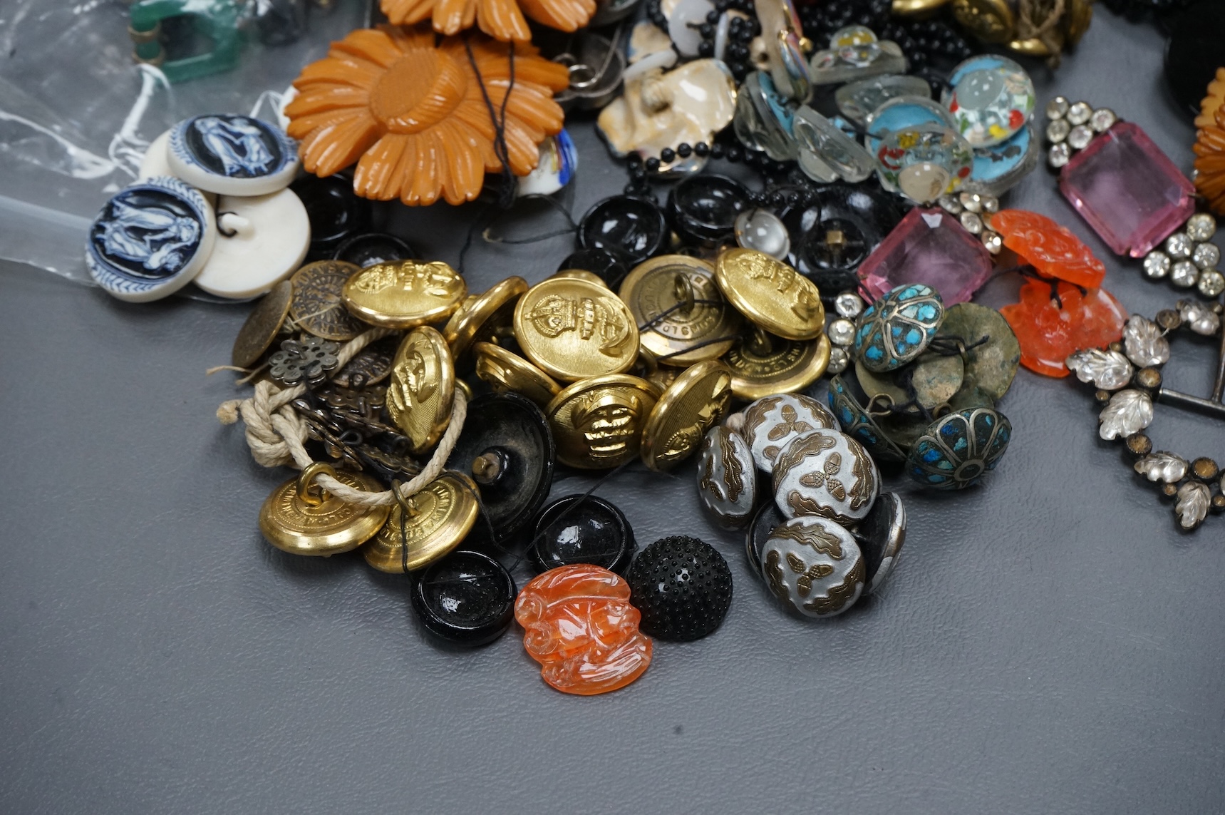 A collection of late 19th and 20th century buttons, some novelty, made from varying materials, metal, bakelite and glass.